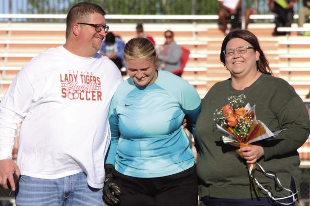 Goal keeper and defender for the Lady Tigers, Zoe Diver is escorted by her parents Michael and Megan Diver.