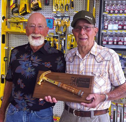 Larry Holderread and Bobby Lofton were recently honored for 50 years of service to Cushing Lumber. Each were awarded a golden hammer. Photo by J. D. Meisner